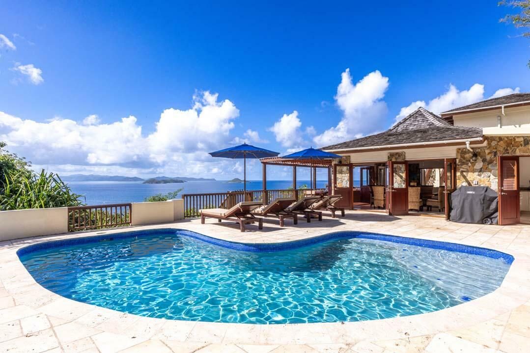 Pool terrace with lounge chairs and umbrellas